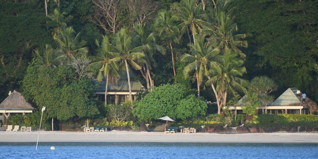 Waterfront cottages at Fiji's exclusive Turtle Island Resort as seen from an offshore boat.
