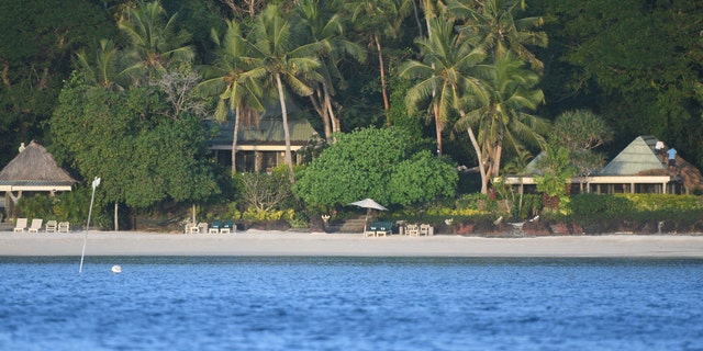 Waterfront cottages at the exclusive Turtle Island Resort in Fiji as seen from a boat offshore.