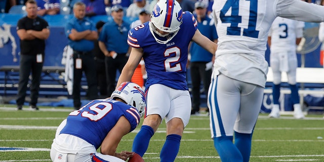 Buffalo Bills placekicker Tyler Bass boots the winning field goal as punter Matt Araiza holds the ball during a preseason game against the Indianapolis Colts in Orchard Park, New York, on Aug. 13, 2022.