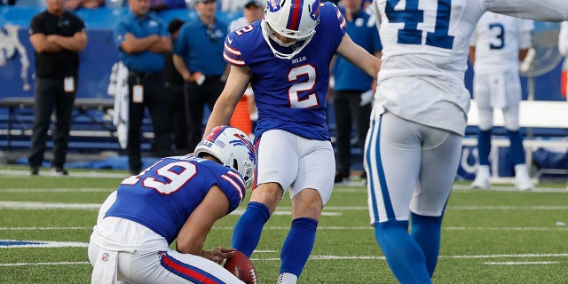 Buffalo Bills placekicker Tyler Bass (2) boots the winning field goal as punter Matt Araiza (19) releases the ball while Indianapolis Colts cornerback Alexander Myres (41) tries to defend in the second half of a preseason NFL football game, Saturday, Aug. 13, 2022, in Orchard Park, N.Y.