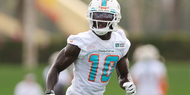 Tyreek Hill #10 of the Miami Dolphins catches a pass during training camp at the Baptiste Health Training Complex in Miami Gardens, Florida, July 27, 2022.