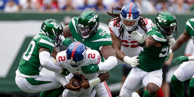 New York Giants quarterback Tyrod Taylor is sacked by New York Jets defensive lineman Quinnen Williams on August 28, 2022 in East Rutherford, New Jersey.