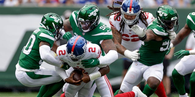 New York Giants quarterback Tyrod Taylor is sacked by New York Jets defensive lineman Quinnen Williams on August 28, 2022 in East Rutherford, New Jersey.