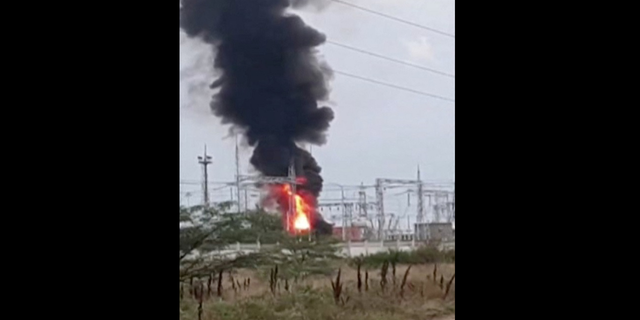 A view shows smoke rising above a transformer electric substation, which caught fire after a blast in the Dzhankoi district, Crimea, on Tuesday, Aug. 16, in this still image from video.