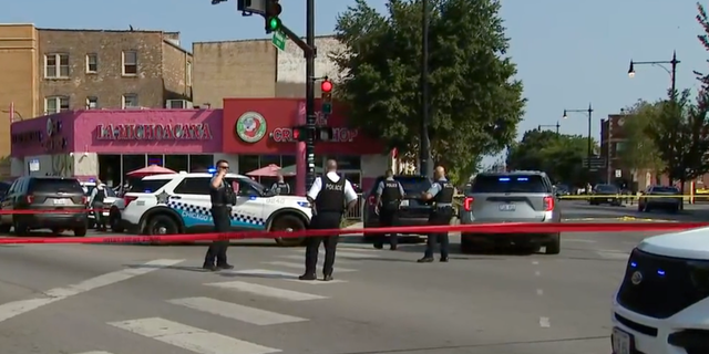 Photo shows a crime scene from August 24, 2022, when four people in Chicago were injured during a drive-by shooting outside a high school on the city's Northwest side.