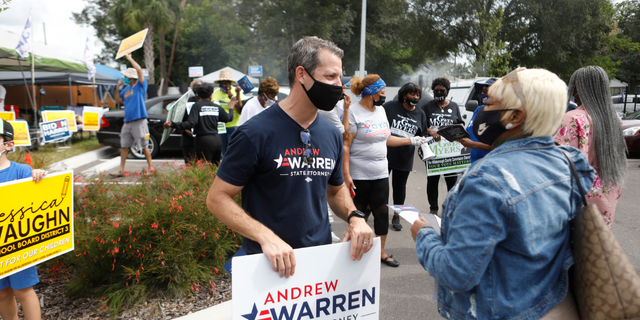 Hillsborough County State Attorney Andrew Warren talks to a voter during the NAACP Hillsborough County Branch Souls to the Polls voter drive on November 1, 2020, in Tampa, Florida.