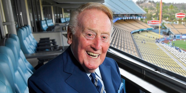 FILE - Los Angeles Dodgers broadcaster Vin Scully poses for a photo ahead of a game between the Dodgers and San Francisco Giants in Los Angeles, California, on September 20, 2016.