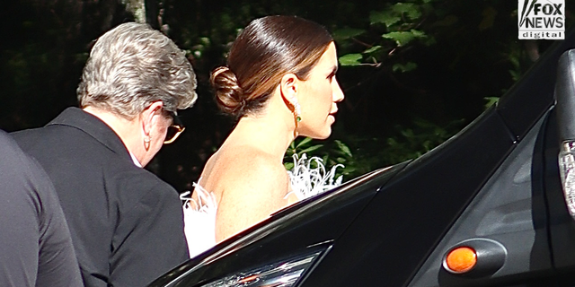 A woman in white arrives at Ben Affleck and Jennifer Lopez's wedding venue.