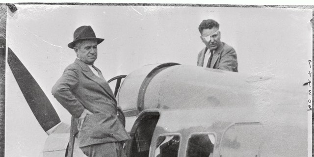 The flyer Wiley Post (at right, with eye patch) and his companion Will Rogers are shown on the wing of the plane just before they left on their fateful trip.