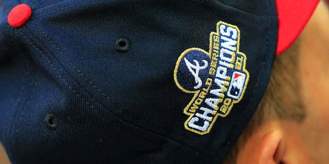 The gold embroidered 2021 World Series Champions logo is displayed on the cap of an Atlanta Braves uniform on April 7, 2022, at Truist Park in Atlanta, Georgia.