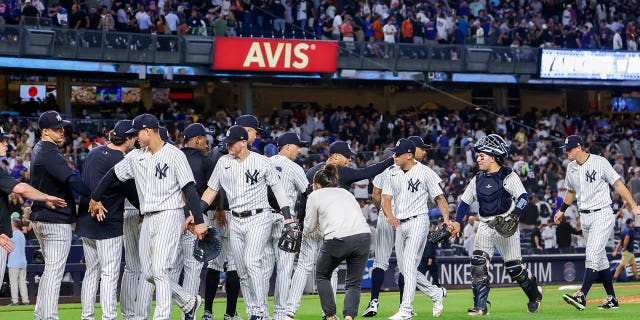 The New York Yankees celebrate their win after a baseball game against the New York Mets, Monday, Aug. 22, 2022, in New York.