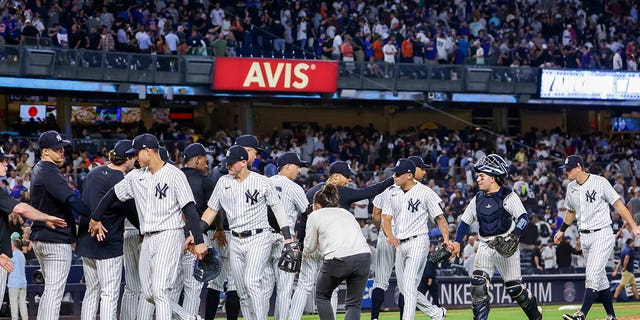 The New York Yankees celebrate their win after a baseball game against the New York Mets, Monday, Aug. 22, 2022, in New York.