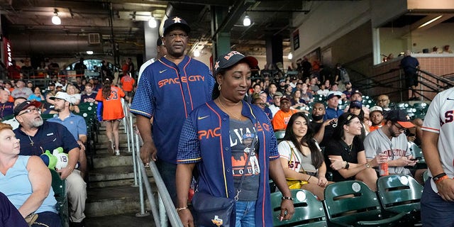 The parents of Houston Astros' Yordan Alvarez, Agustín Eduardo Álvarez Salazar, rear, and Mailyn Cadogan Reyes walk to their seats to watch the Minnesota Twins and Houston Astros play a baseball game Tuesday, Aug. 23, 2022, in Houston. Alvarez's parents got to see him play as a professional for the first time Tuesday night after arriving from Cuba Friday.