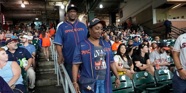 Houston Astros Jordan Alvarez, Agustin Eduardo Alvarez Salazar, back and Mylene Cadogan Reyes take their seats to watch the Minnesota Twins and Houston Astros play a baseball game Tuesday, Aug. 23, 2022, in Houston.  Alvarez's parents saw him play as a professional Tuesday night for the first time since arriving from Cuba on Friday.