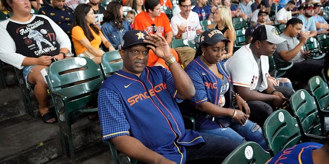 The parents of Houston Astros' Yordan Alvarez, Agustín Eduardo Álvarez Salazar, left, and Mailyn Cadogan Reyes watch the Minnesota Twins and Houston Astros play a baseball game Tuesday, Aug. 23, 2022, in Houston. Alvarez's parents got to see him play as a professional for the first time Tuesday night after arriving from Cuba Friday.
