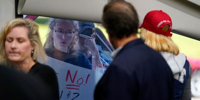 Abortion opponents are seen outside as the Michigan Board of State Canvassers meet during a hearing, Wednesday, Aug. 31, 2022, in Lansing, Mich.