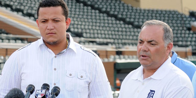 Miguel Cabrera, left, of the Detroit Tigers looks on as Tigers Vice President and Assistant General Manager Al Avila speaks to the media during a press conference at spring training on Feb. 24, 2011, in Lakeland, Florida.