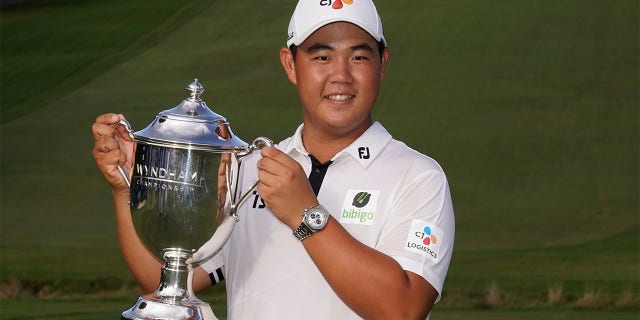 Joohyang Kim of South Korea poses with the trophy after winning the Wyndham Championship golf tournament, Sunday, June 7, 2022, in Greensboro, NC.