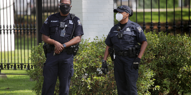 BATON ROUGE, LOUISIANA - APRIL 17: Members of the police stand by as protestors gather outside the Louisiana State Governor's mansion during a rally against Louisiana's stay-at-home order and economic shutdown on April 17, 2020 in Baton Rouge, Louisiana. Governor John Bell Edwards has said Louisiana’s high rate of infections and deaths does not position the state to quickly open back up. (Photo by Chris Graythen/Getty Images)