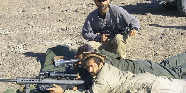 Perry Blackburn, founder of AFG Free and a former commander with 5th Special Forces group, trains an Afghan fighter during the 2001 invasion of Afghanistan
