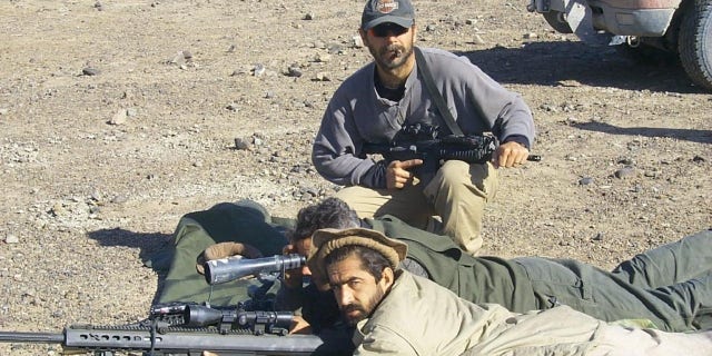 AFG Free founder and former commander of the 5th Special Forces Group, Perry Blackburn, trains Afghan fighters during the 2001 invasion of Afghanistan.