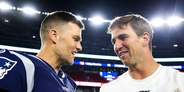 Tom Brady of the New England Patriots greets Eli Manning of the New York Giants after a preseason game at Gillette Stadium on August 29, 2019 in Foxborough, Massachusetts.