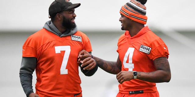 Jacoby Brissett #7 and Deshaun Watson #4 of the Cleveland Browns laugh during Cleveland Browns training camp at CrossCountry Mortgage Campus on July 27, 2022 in Berea, Ohio.