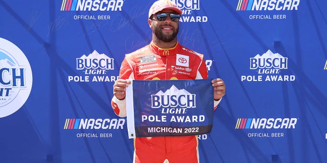 Bubba Wallace, driver no. 23 McDonald's Toyota poses for photographs after winning pole position during qualifying for the NASCAR Cup FireKeepers Casino 400 series at Michigan International Speedway in August. September 6, 2022 in Brooklyn, Michigan.