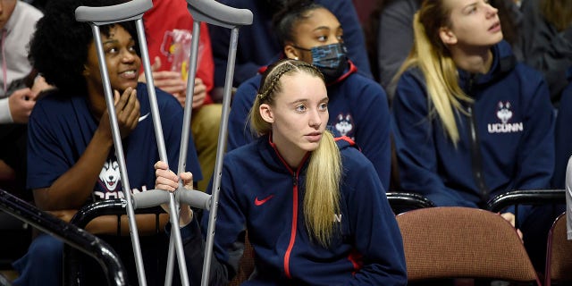 Paige Bueckers of the Connecticut Huskies watches a game between the Michigan Wolverines and the Baylor Lady Bears in the Basketball Hall of Fame Women's Showcase at Mohegan Sun Arena Dec. 19, 2021, in Uncasville, Conn.