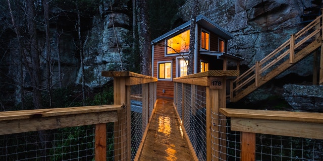 The first floor of Cliff Dweller seen lit up at night. Red River Gorge, Kentucky.