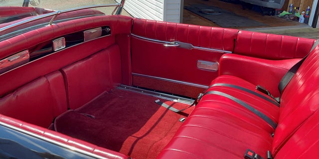 The car has a separate rear passenger compartment with extra seats that fold out from the bulkhead.
