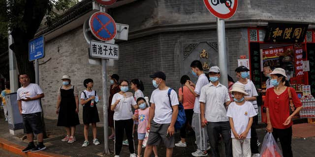 People seen wearing face masks outside as smaller Chinese cities begin blocking measures.  Photo taken in Beijing, China, 3 August 2022.