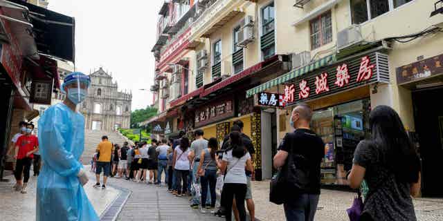 Chinese citizens wait in line for COVID tests near the Saint Paul Ruins in Macau, China, on June 20, 2022.