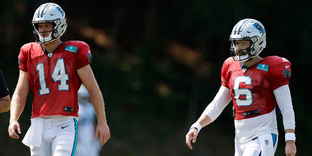 Sam Darnold (14) and Baker Mayfield (6) of the Carolina Panthers during training camp at Wofford College Aug. 2, 2022, in Spartanburg, S.C.