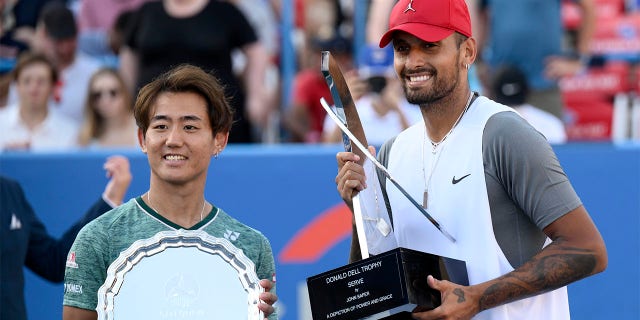 Sunday in Washington, Aug. Nick Kyrgios, right, of Australia poses with the winner's trophy after defeating Yoshihito Nishioka, left, of Japan, in the final at the City Open tennis tournament, 7, 2022. Kyrgios won 6-4, 6-3.