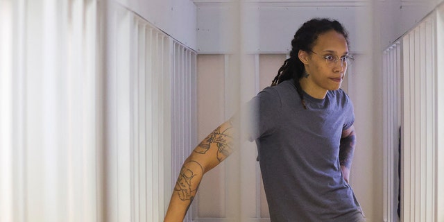 WNBA basketball player Brittney Griner, who was detained at Moscow's Sheremetyevo airport and later charged with illegal possession of cannabis, waits for the verdict inside a defendants' cage during a hearing in Khimki outside Moscow, on August 4, 2022. 