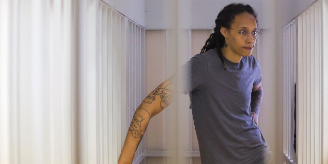 WNBA basketball player Brittney Griner, who was detained at Moscow's Sheremetyevo airport and later charged with illegal possession of cannabis, waits for the verdict inside a defendants' cage during a hearing in Khimki outside Moscow, on August 4, 2022.