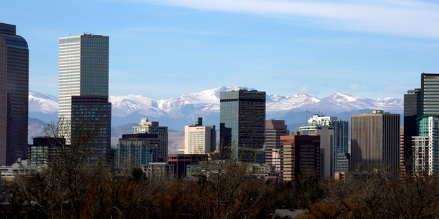 The Continental Divide is seen in the background behind the downtown city skyline in Denver, Colorado, Nov. 16, 2017.
