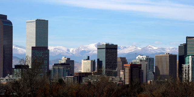 The Continental Divide is seen in the background behind the downtown city skyline in Denver, Colorado, U.S., November 16, 2017. REUTERS/Rick Wilking