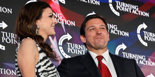 Florida Governor Ron DeSantis brings his wife Casey DeSantis on stage during a campaign event for Republican Senate candidate J.D. Vance run by Turning Point Action in Youngstown, Ohio, U.S., August 19, 2022. 