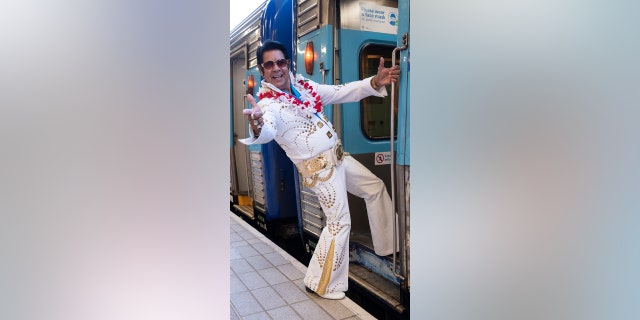 An Elvis impersonator boards the Elvis Express at Central Station on April 21, 2022 in Sydney, Australia.