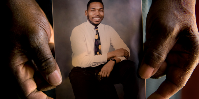 Charles Harkleff holds a picture of Leonardo Johnson circa mid 1980's who was shot and survived the attack on the Family Research Council in Washington, DC on August 15, 2012. Johnson was on duty guarding the Family Research Council when gunman, Floyd Lee Corkins came into the building.