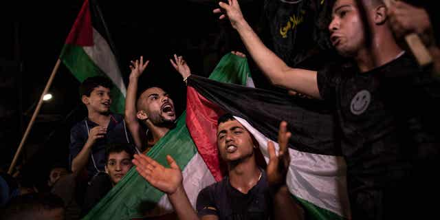 Palestinians celebrate in Gaza City after reaching a ceasefire on Monday morning.