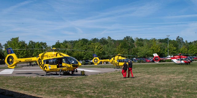 Rescue helicopters are seen in a field near the 'Legoland' amusement park in Guenzburg, southern Germany, on Thursday.