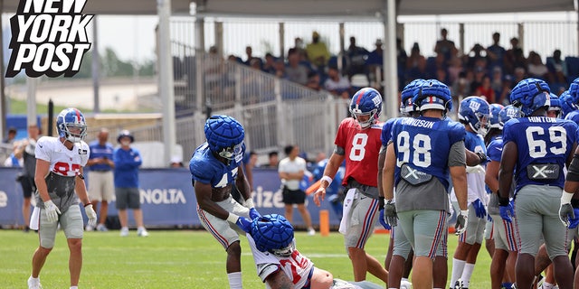 New York Giants linebacker Cam Brown drags guard Jon Feliciano during a fight that broke out between the offense and the defense at training camp on Monday, Aug. 8, 2022, at the Giants training facility in East Rutherford, New Jersey.