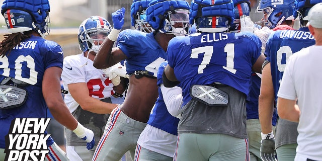 New York Giants linebacker Cam Brown, center, is about to throw a punch during a fight that broke out between the offense and the defense at training camp on Monday, Aug. 8, 2022, at the Giants training facility in East Rutherford, New Jersey.