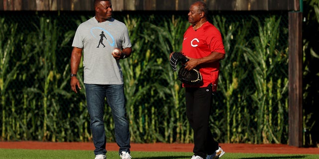 Former baseball player Ken Griffey Jr. (L) and his father Ken Griffey Sr. take the field for the game between the Chicago Cubs and Cincinnati Reds at Field of Dreams on August 11, 2022 in Dyersville, Iowa.