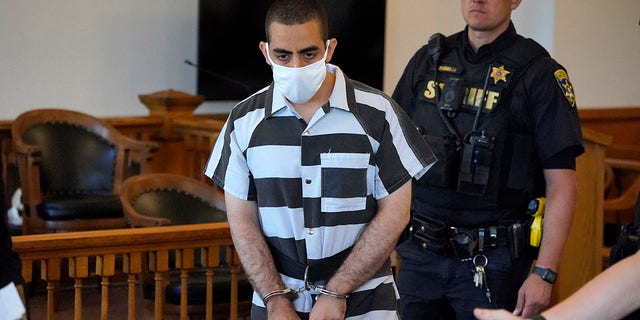 Hadi Matar, 24, center, arrives for an arraignment in the Chautauqua County Courthouse in Mayville, N.Y., on Aug. 13, 2022.