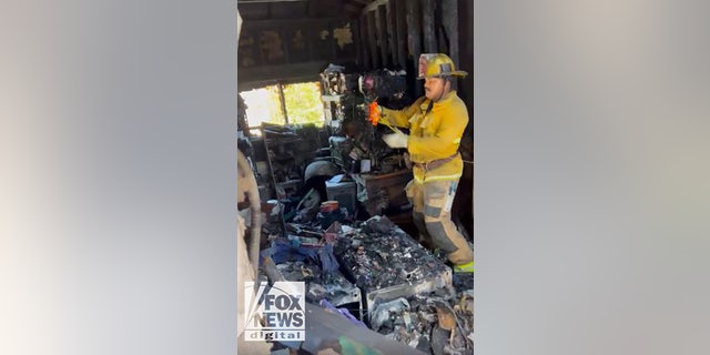 A firefighter took measurements in Lynne Mishele's home after Anne Heche's crash. Heche was removed from life support Sunday following the crash.