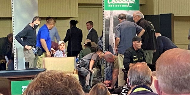 A view of who appears to be author Salman Rushdie treated by emergency personnel after being stabbed on stage before his scheduled speech at the Chautauqua Institution in Chautauqua, New York, U.S., August 12, 2022, in this picture obtained from social media. 